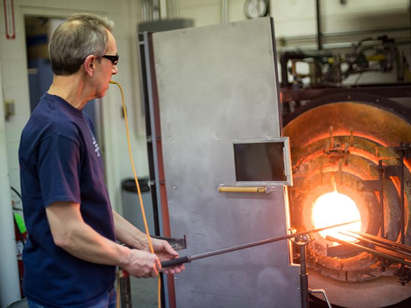 Distinguished Professor of Materials Science and Engineering Carlo Pantano shapes glass at his glass blowing studio in the Hosler Building.