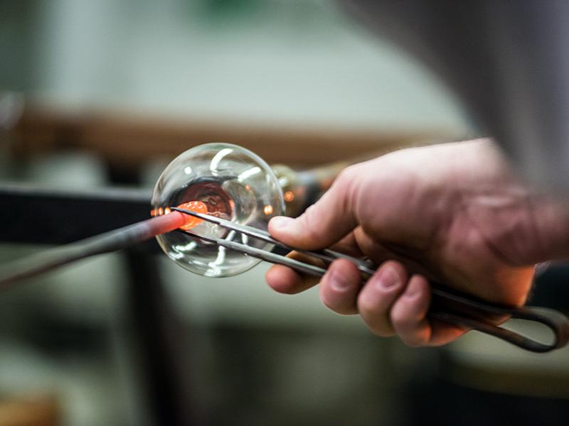 Distinguished Professor of Materials Science and Engineering Carlo Pantano shapes glass at his glass blowing studio in the Hosler Building. 