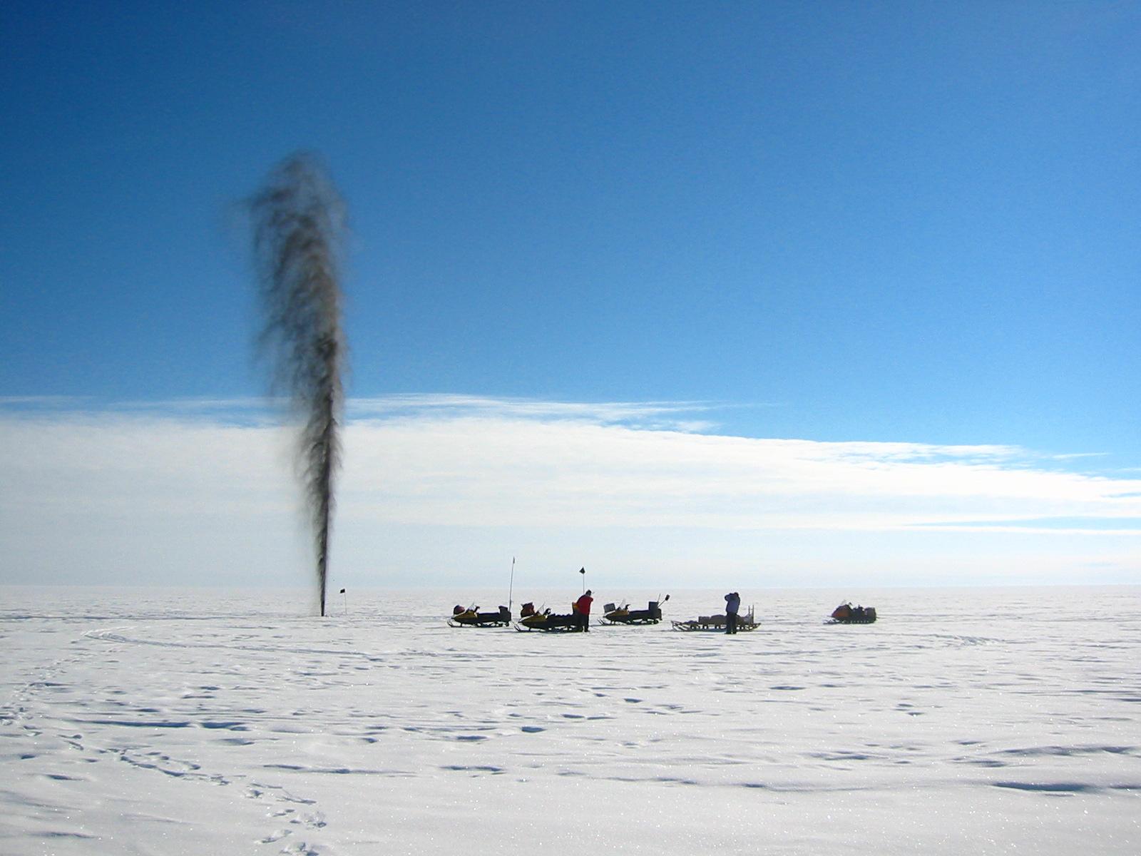 Ice and dirt gush out of a shot hole in Antarctica