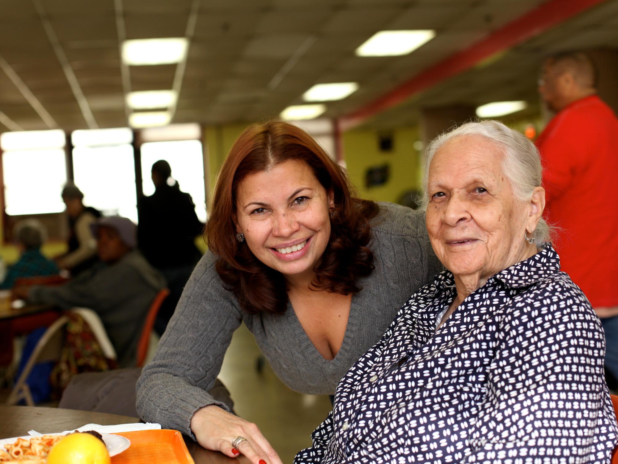 A geriatric caregiver with an older adult patient.