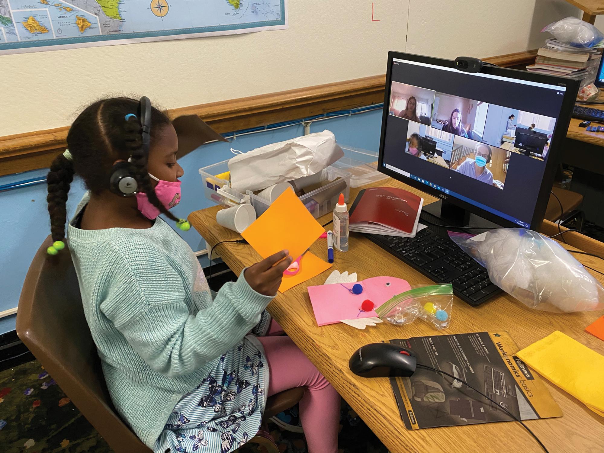 An elementary student works on a science experiment with her pre-service teacher from Penn State via Zoom.