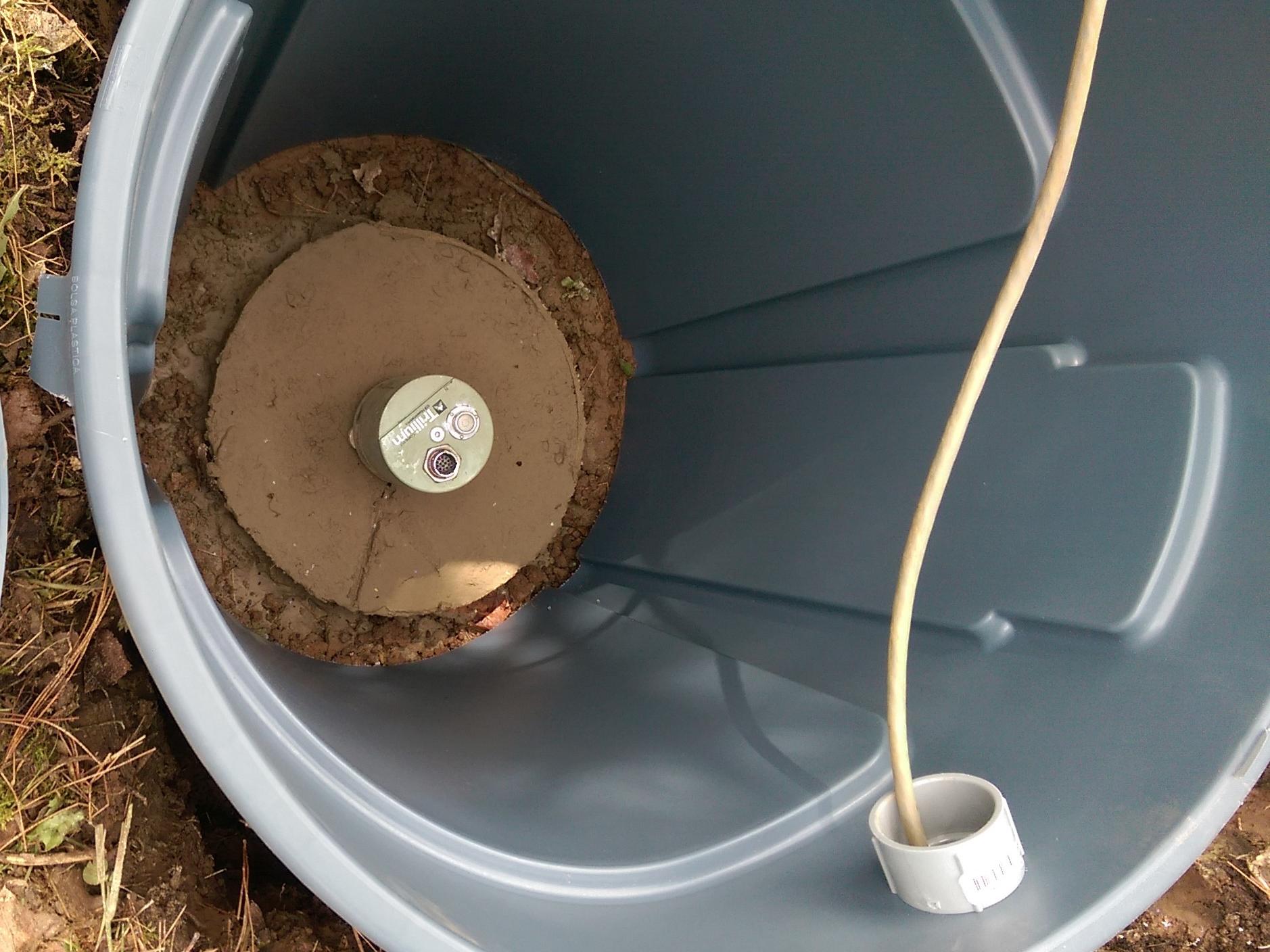 A PASEIS seismometer sits on a concrete slab belowground.