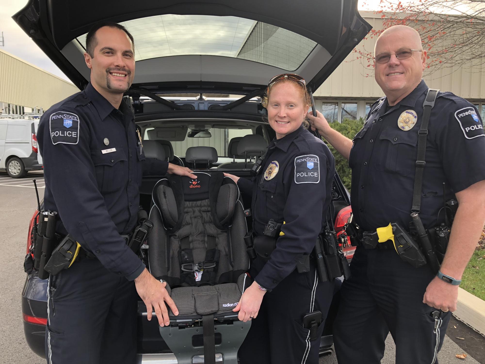 Police officers with car seat