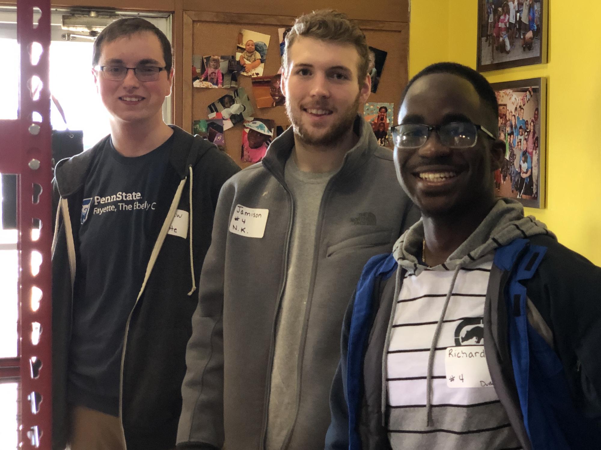 three students smiling 