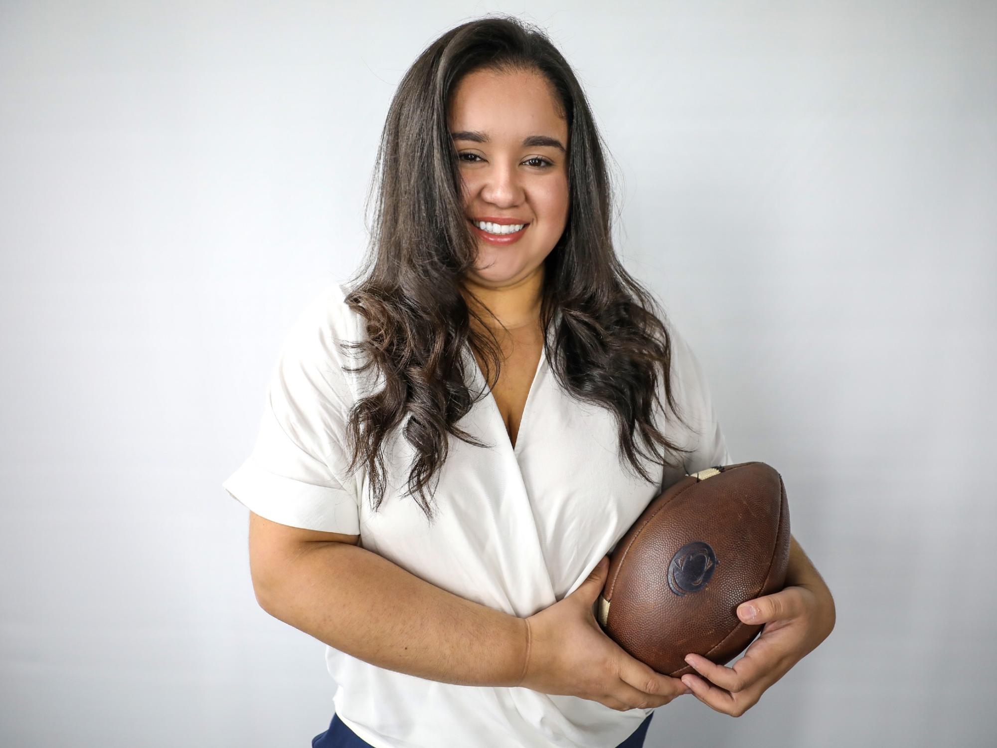 Destiny Rodriguez holding a football.