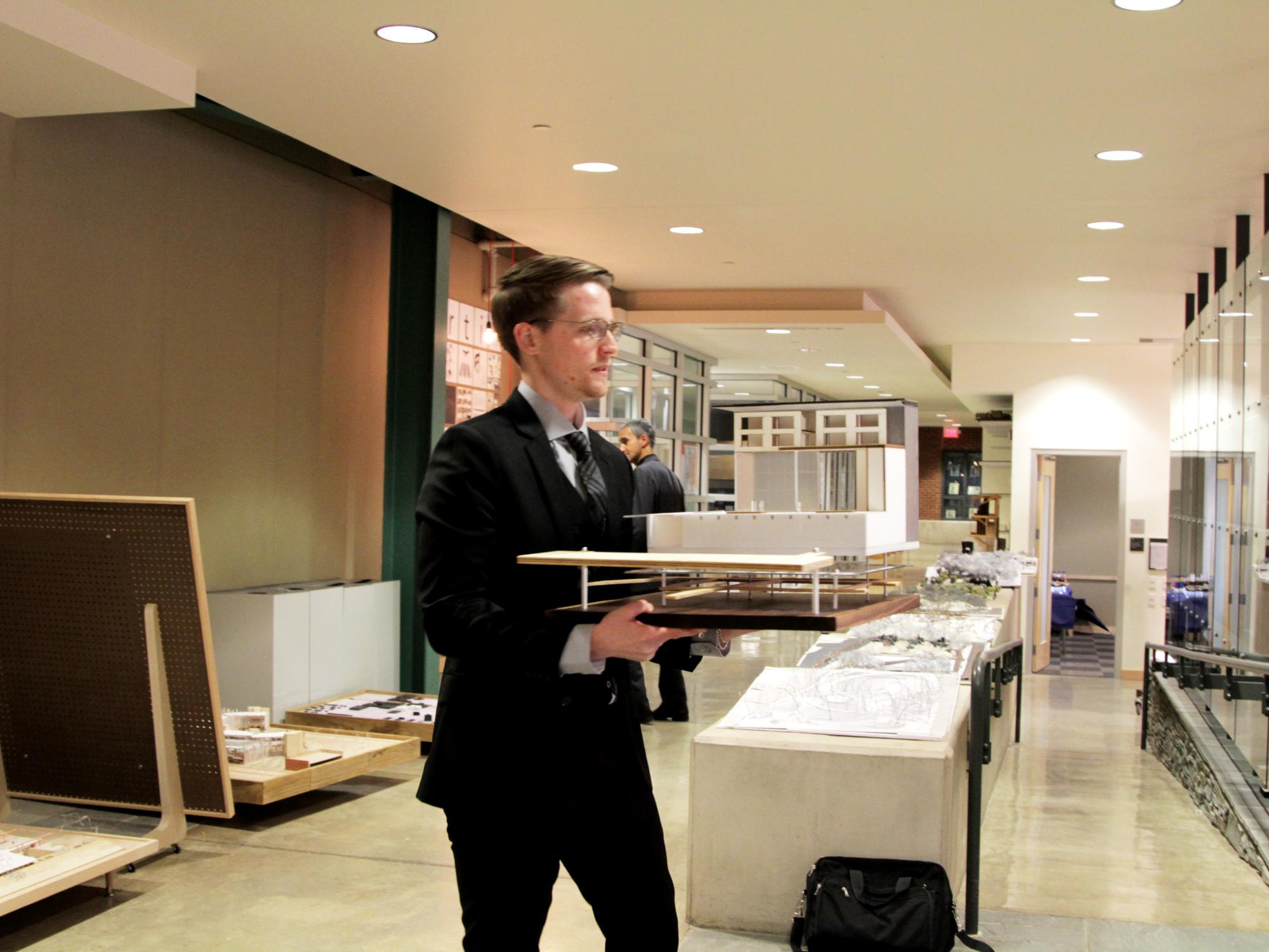 Dustin Julius carrying his model for his Kossman presentation