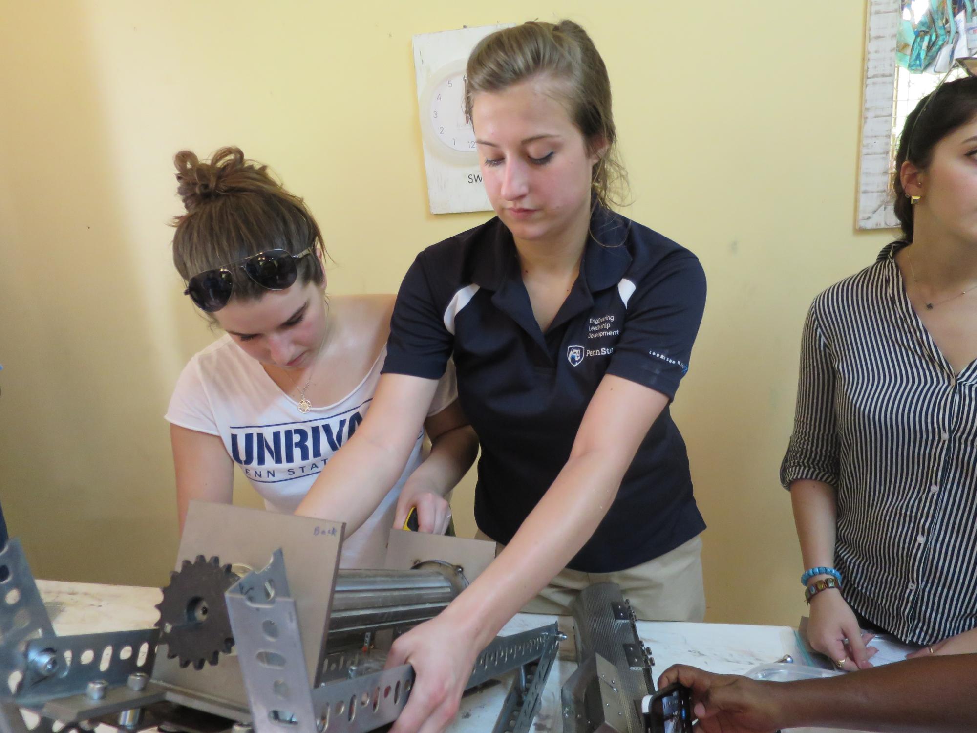 Penn State students use a machine to separate the different components of the baobab fruit