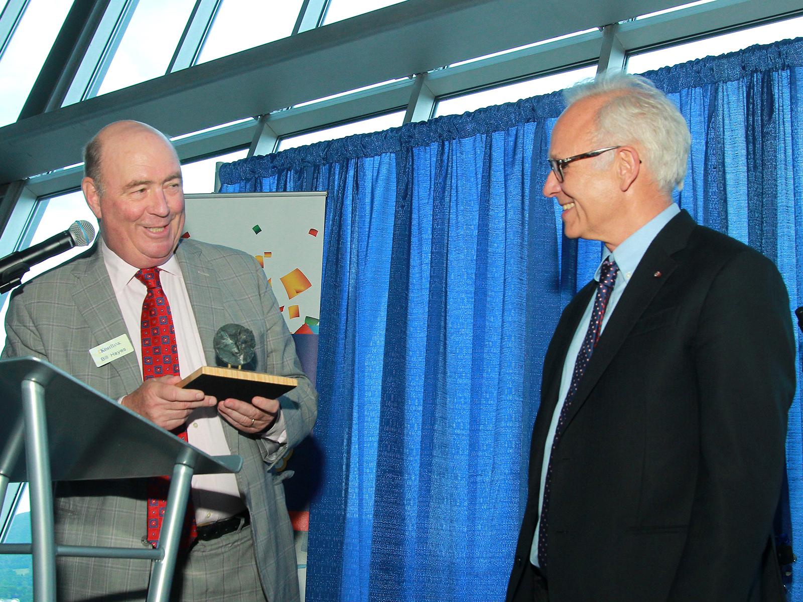Kish Bank official hands award to Peter Hudson