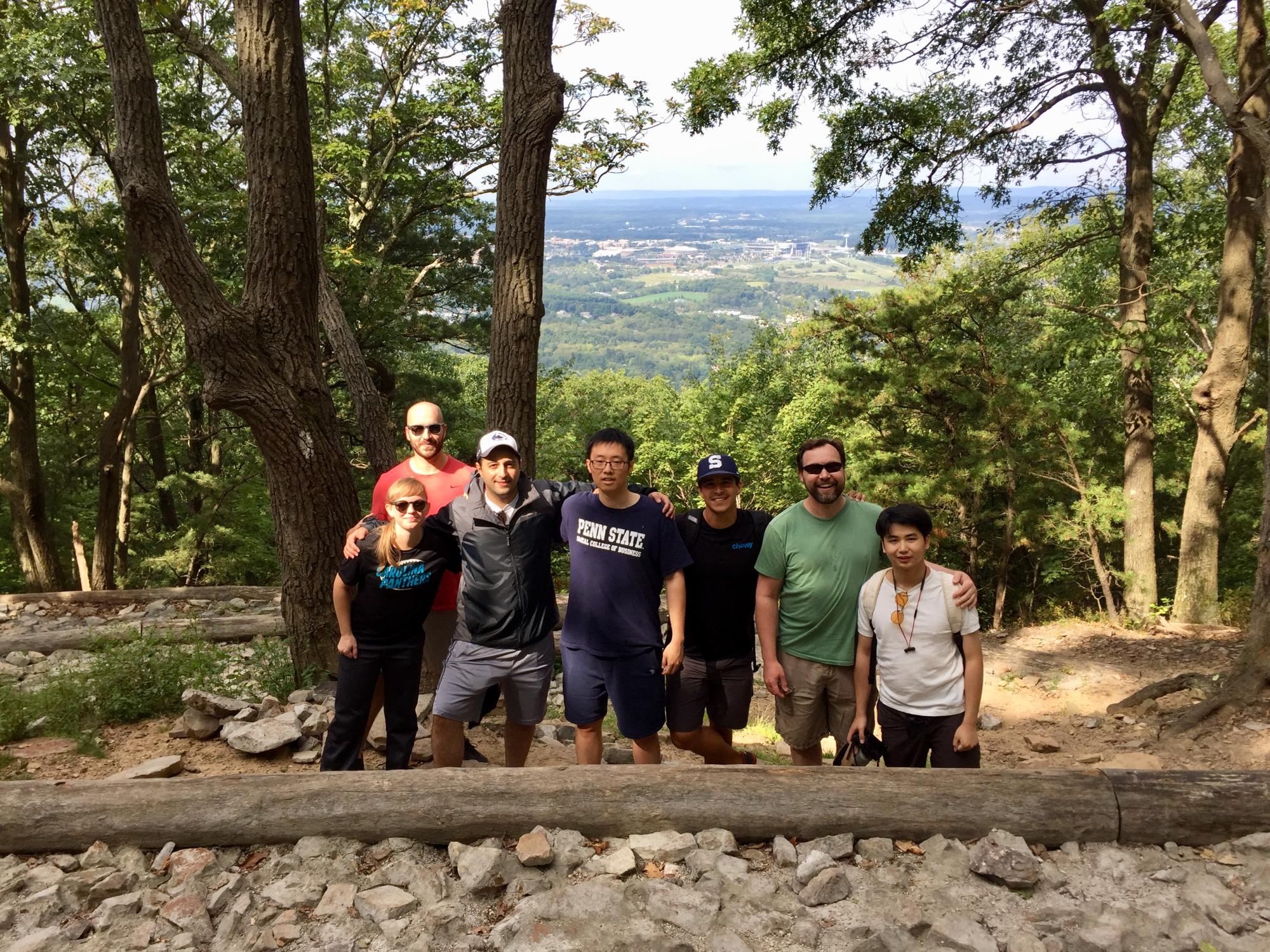A group of Smeal PGP students and PGP admissions director stop to pose while hiking Mt. Nittany. 