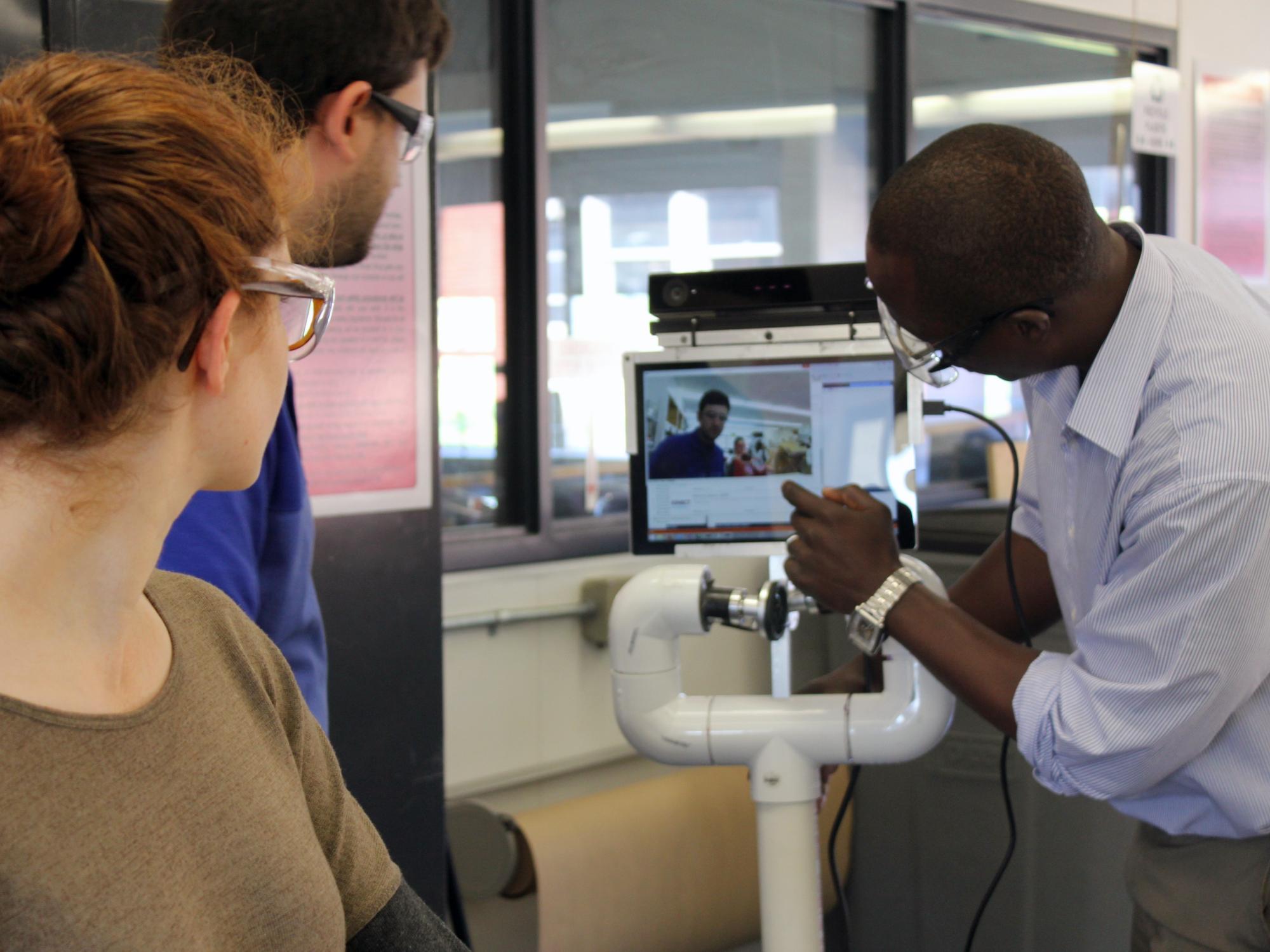 NSF National Robotics Initiative Principle Investigator Conrad Tucker calibrates the data acquisition functionality of co-robot Pennie's sensing system.