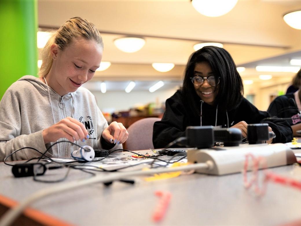 Two girls work with a 3D printing pen