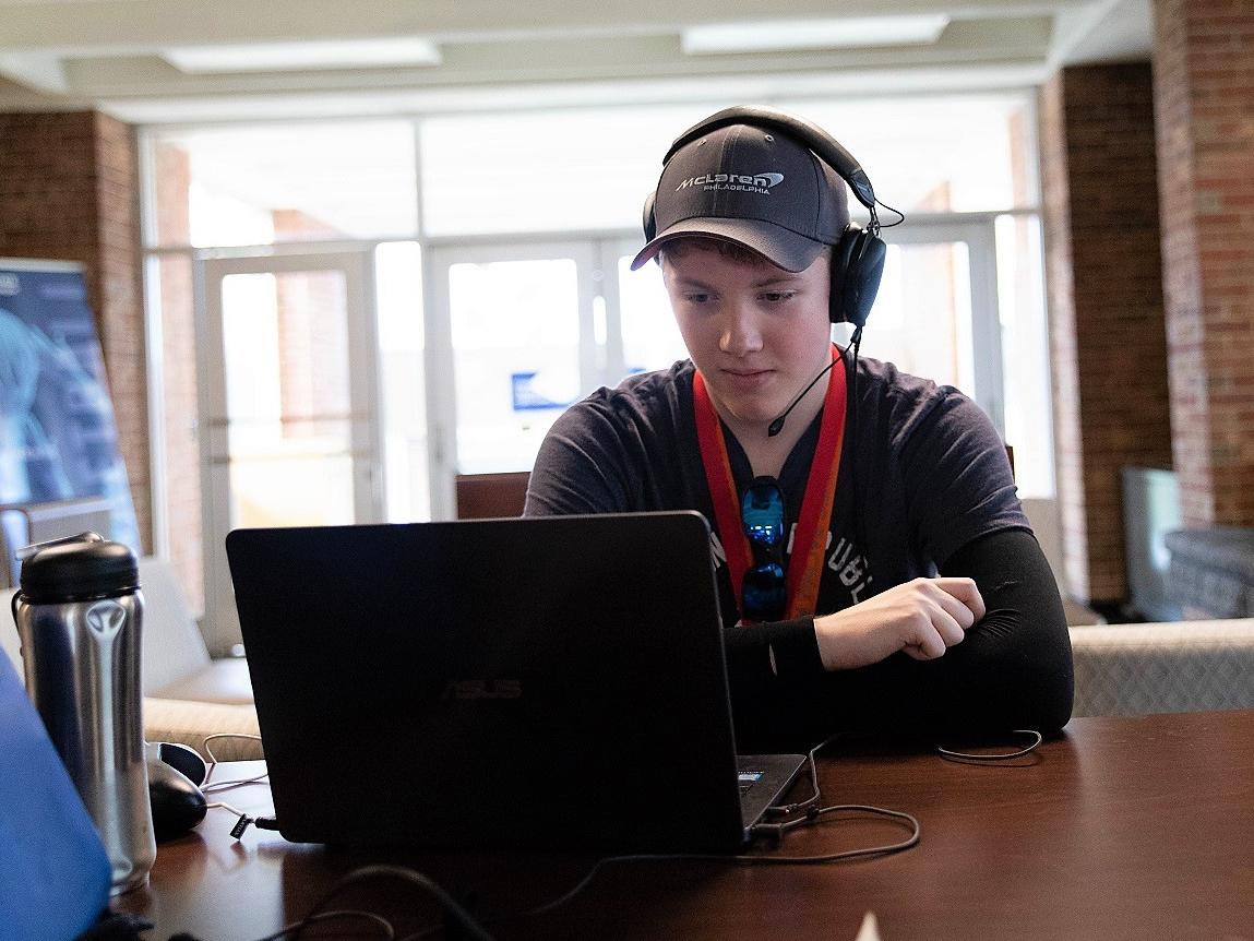 Mackinly Adams sits at laptop