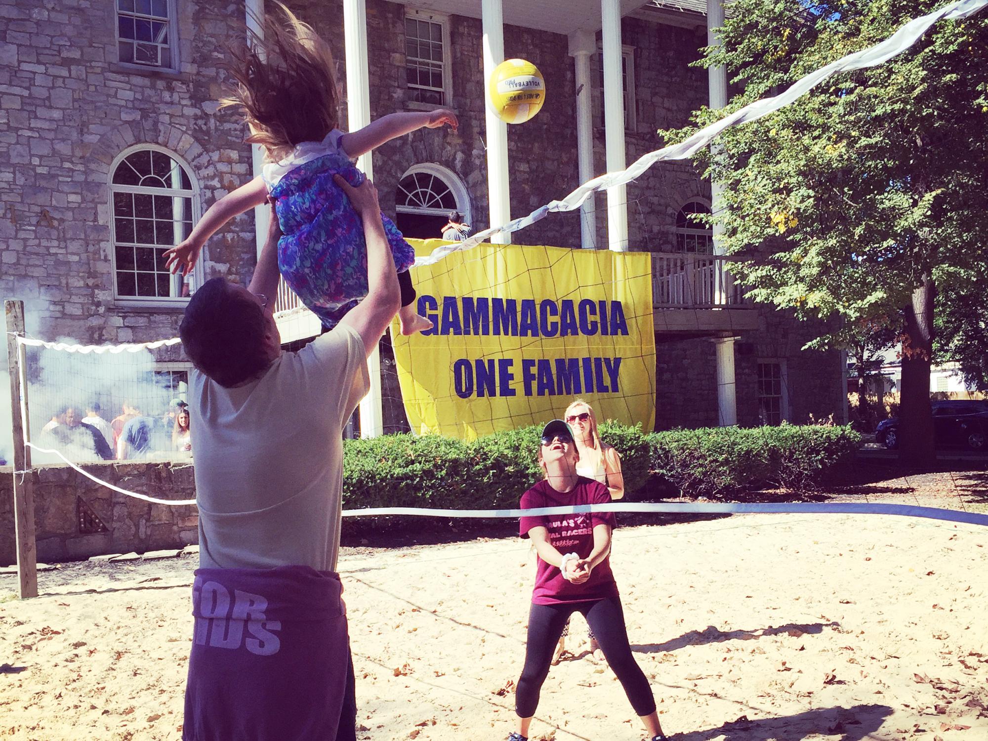 Paula plays volleyball at a cookout organized for the Engel-Herbert family by her GammAcacia THON team.