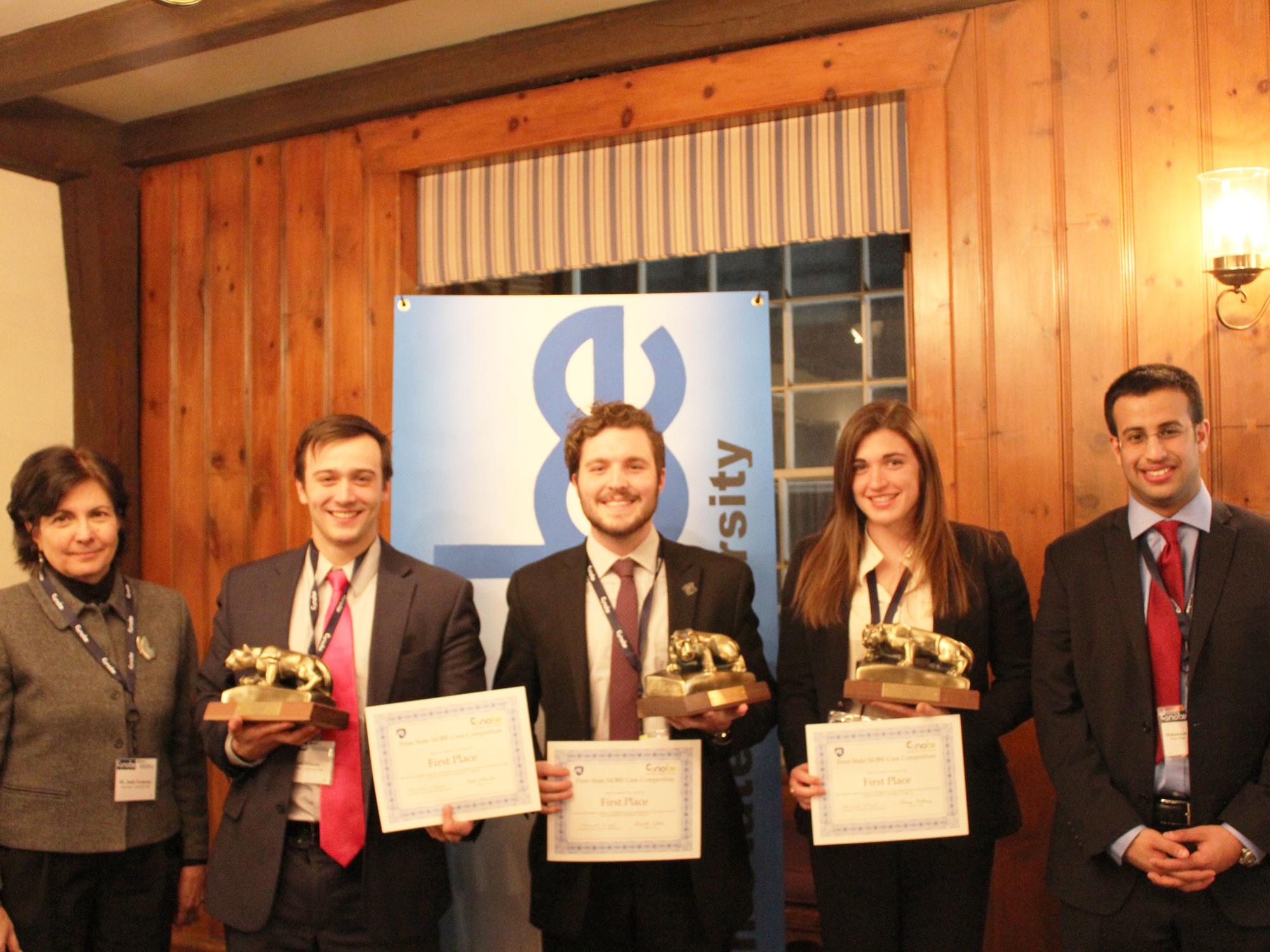 Janis Terpenny, head of the Marcus department, and Mohammad AlZayed, president of the Penn State NOBE chapter, with the members of the first-place Harvard Business Review Case Competition team.