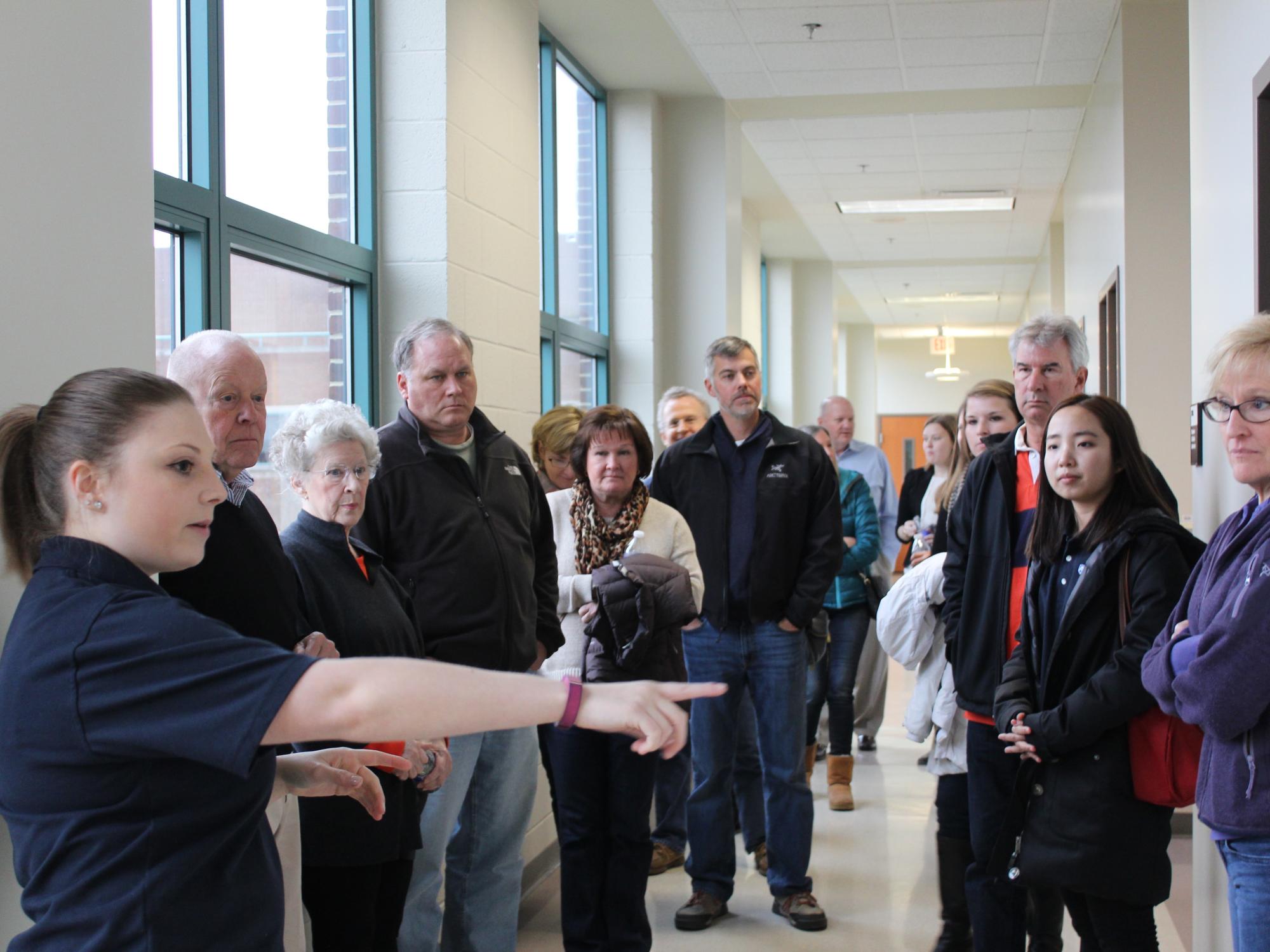 Families of industrial engineering students on a tour of the IME department's facilities