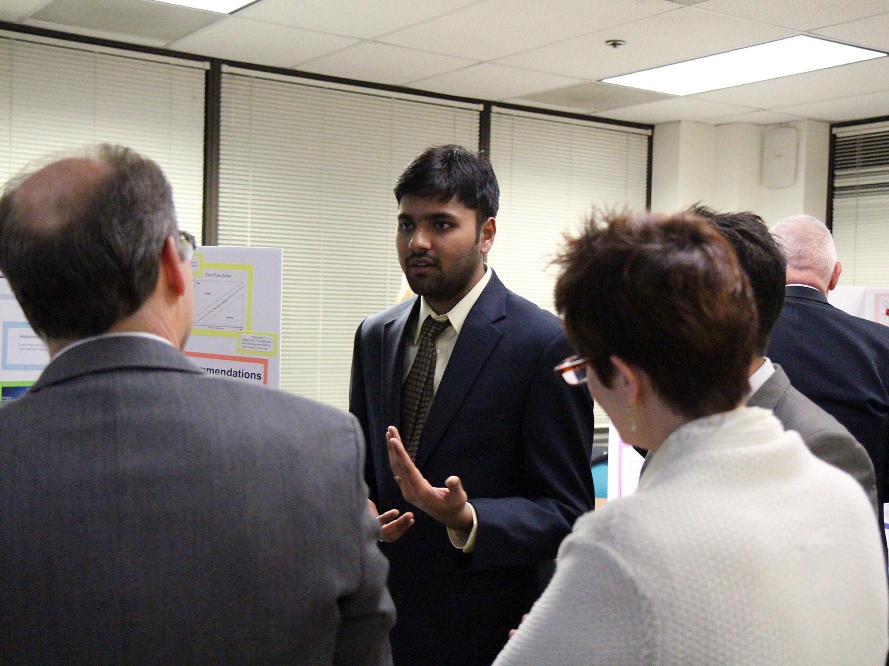 MBA student Kaushik Krishnaswamy Kumar conversing with judges