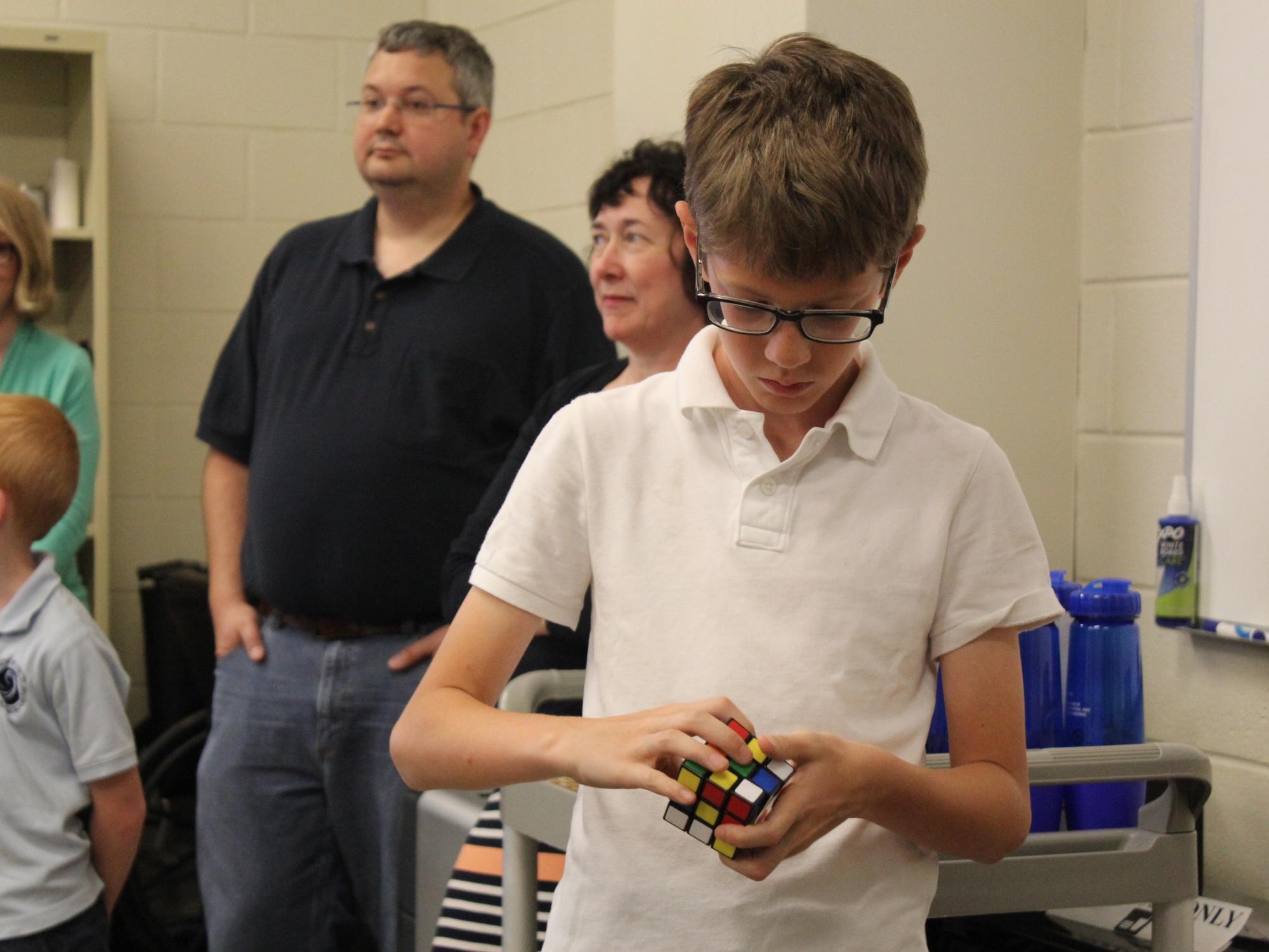 Fifth-grader Sam Viglione tries to solve the Rubik's Cube.