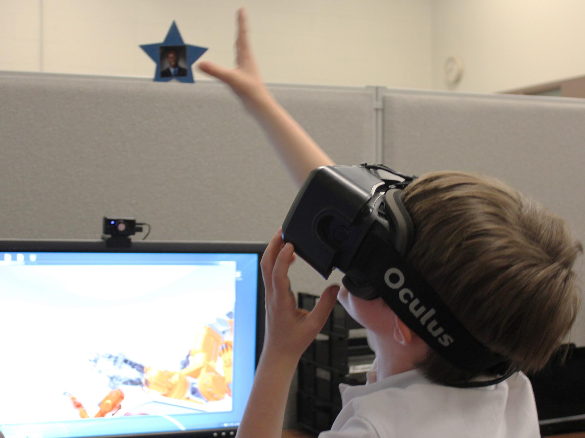 A student tests out the Oculus Rift headset and gets a feel for a virtual realtiy environment.