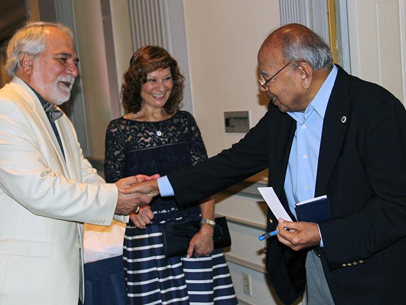 Turgay Ertekin, professor of petroleum and natural gas engineering, left, and his wife, Filiz, greet Raja Ramani, Professor Emeritus of mining engineering and geo-environmental engineering.