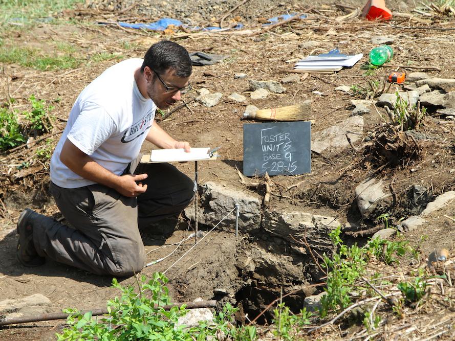 A student examines the dig site. 