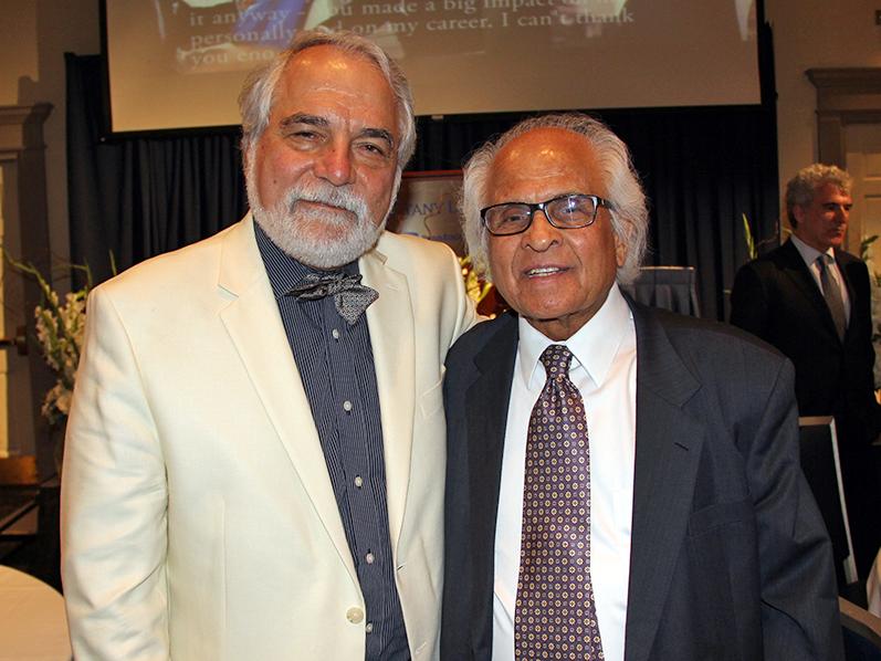 Turgay Ertekin, professor of petroleum and natural gas engineering, left, takes a photo with S.M. Farouq Ali during Ertekin's retirement celebration.