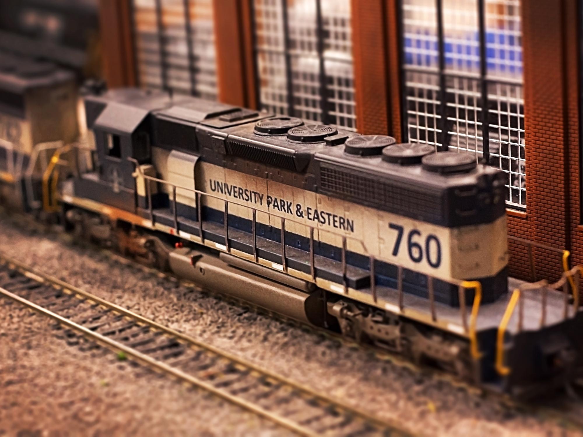 A train car with the words "University Park & Eastern" on the side of it. 