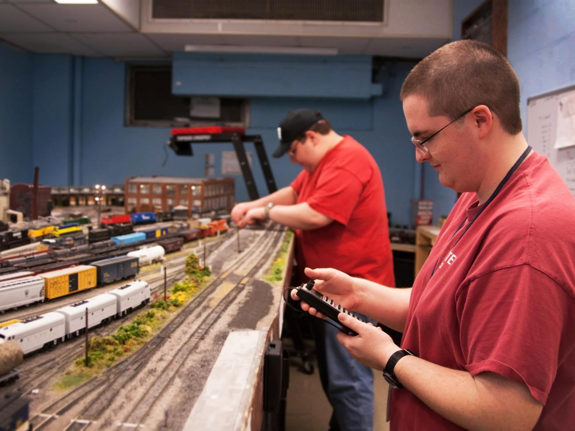 William Chittester uses a handheld device to control a locomotive. 
