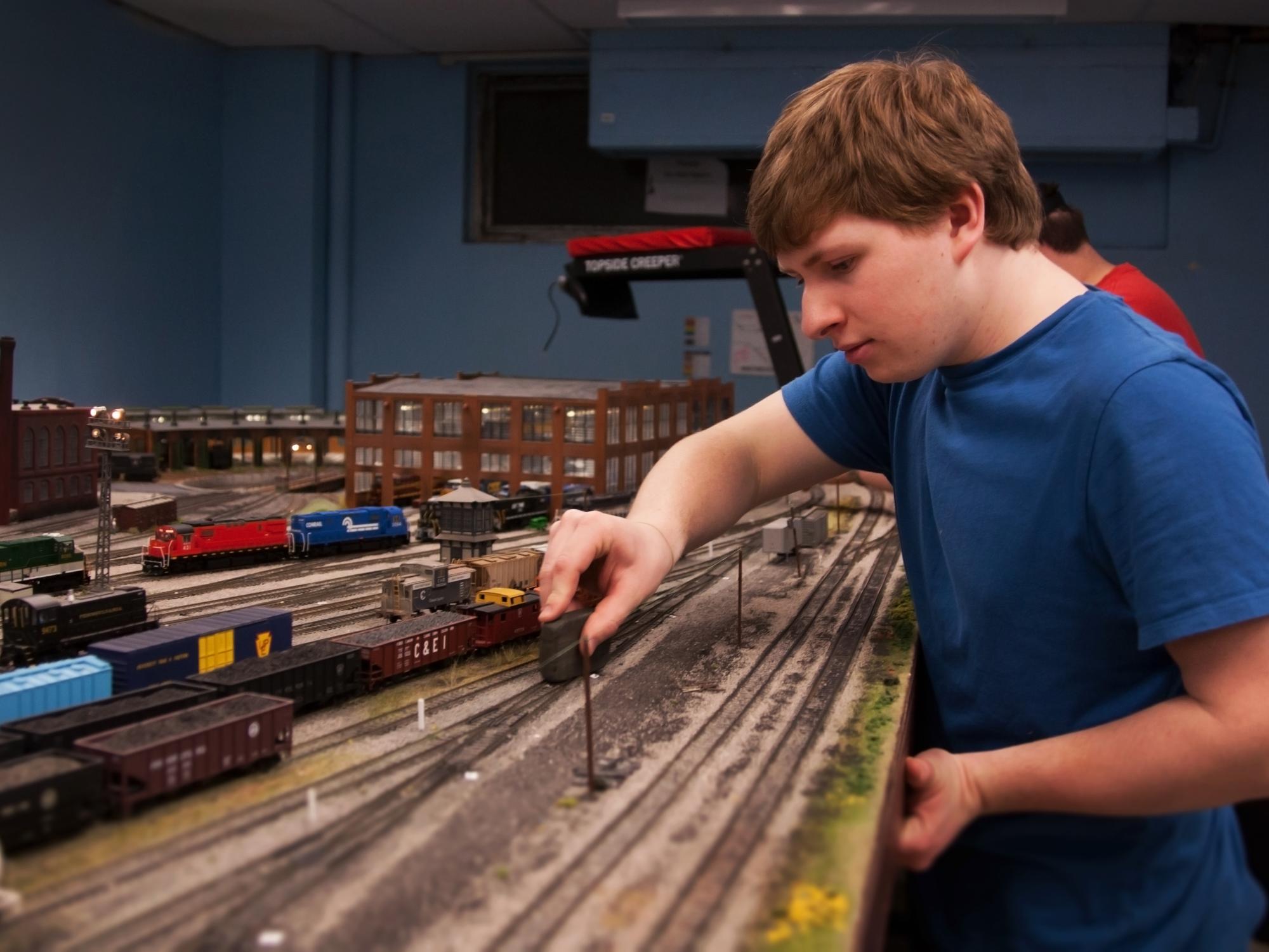 Michael Dempsey cleans the railroad track 