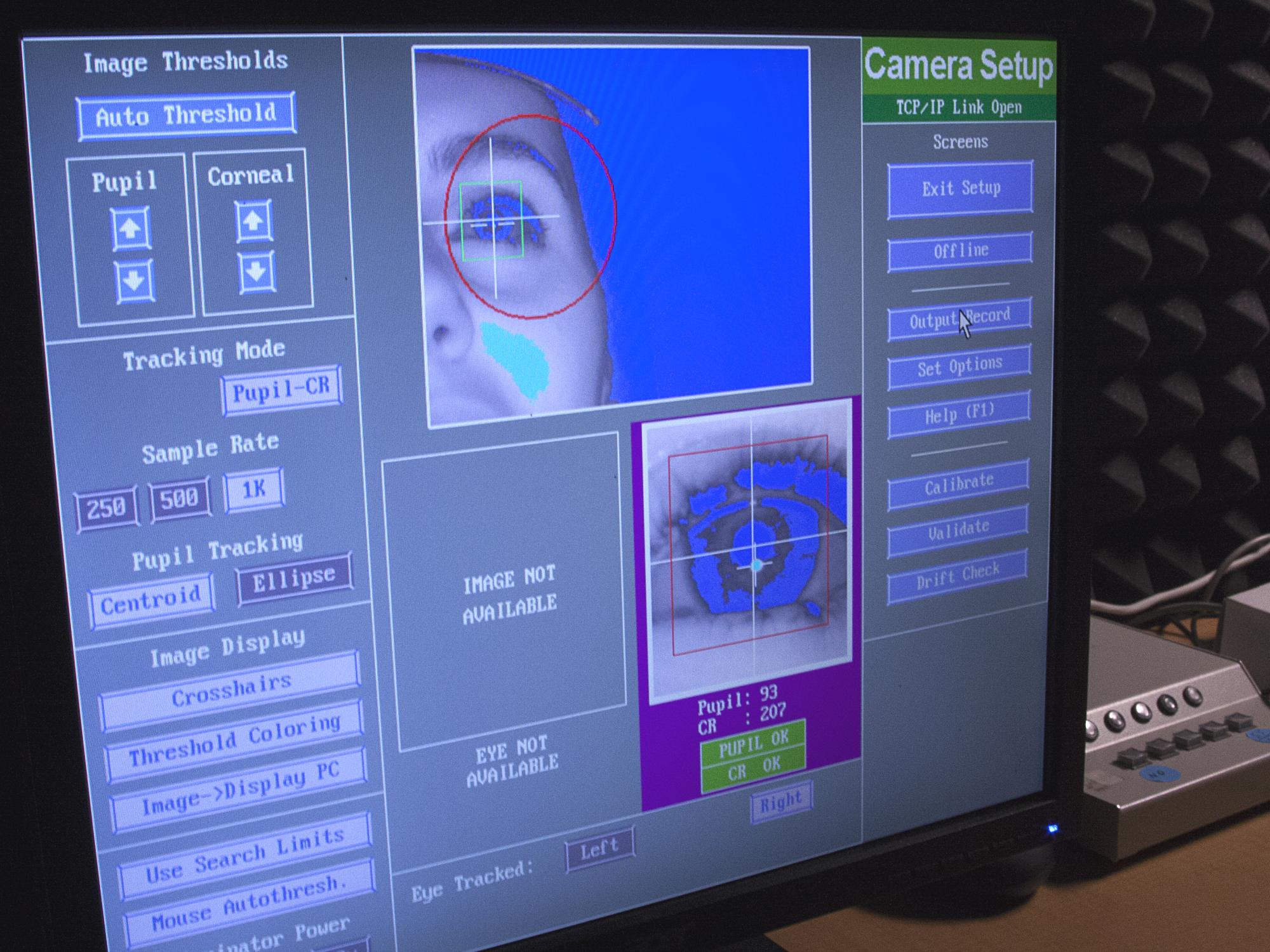 A computer shows a calibration screen from the eye-tracking device 
