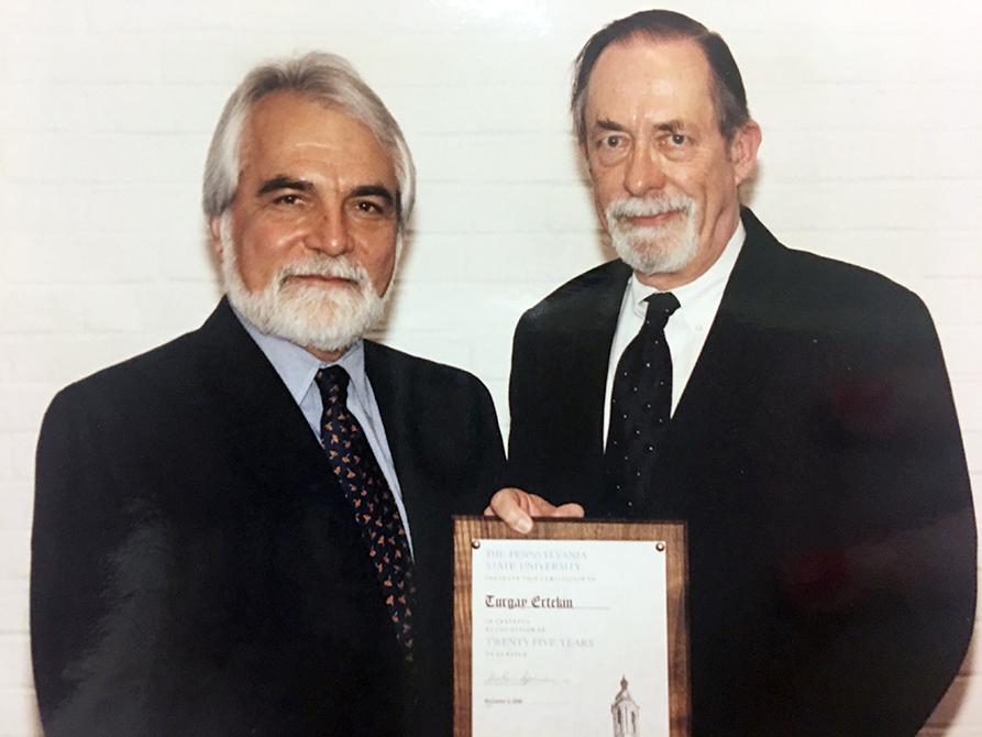Turgay Ertekin, professor of petroleum and natural gas engineering, left, is awarded for 25 years of service by John Dutton, Professor Emeritus of Meteorology and Dean Emeritus, College of Earth and Mineral Sciences.
