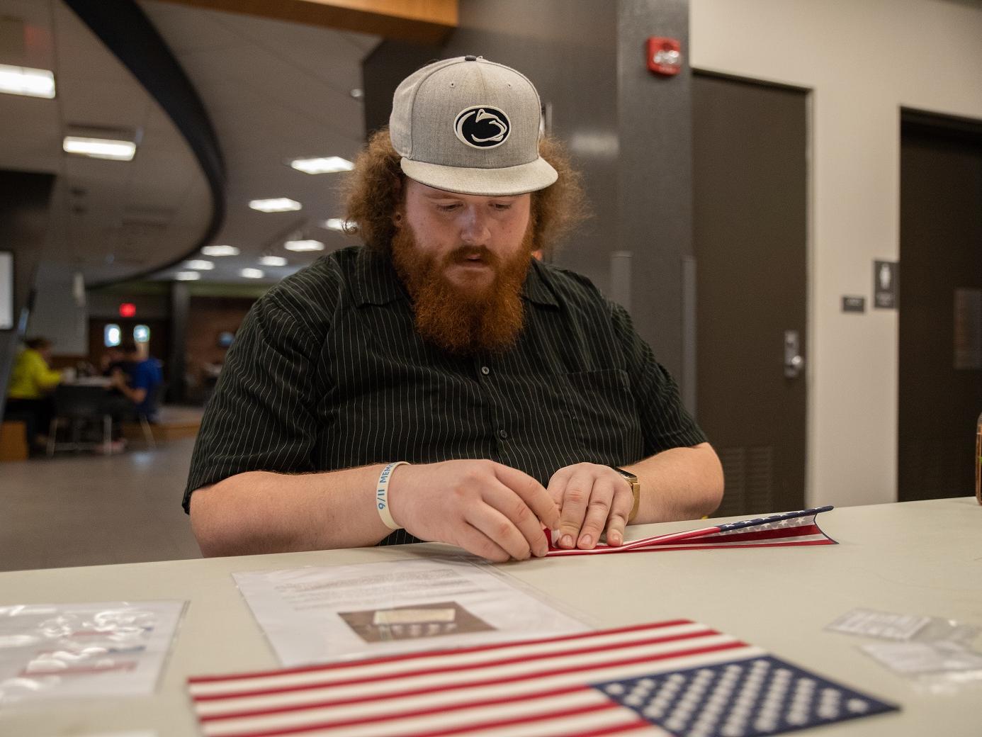 Student folds flag
