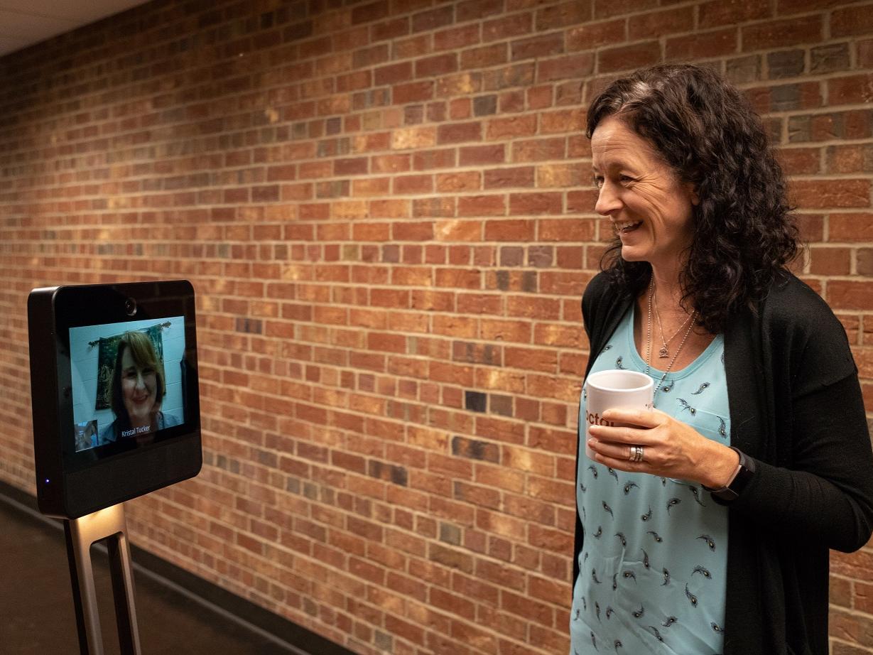 Kristal Tucker and Penelope Morrison interact via robot