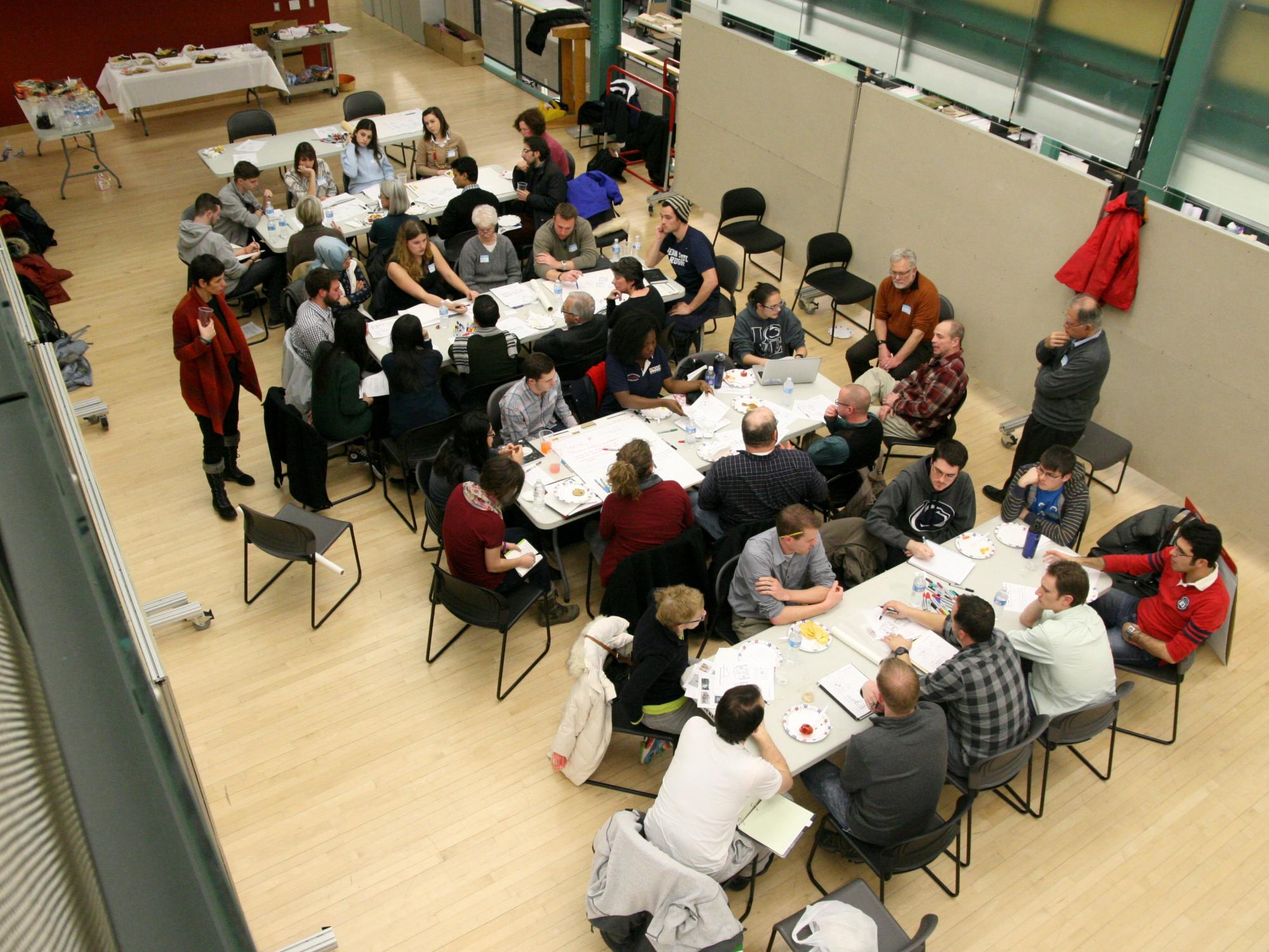 Overhead view of group of people working around tables