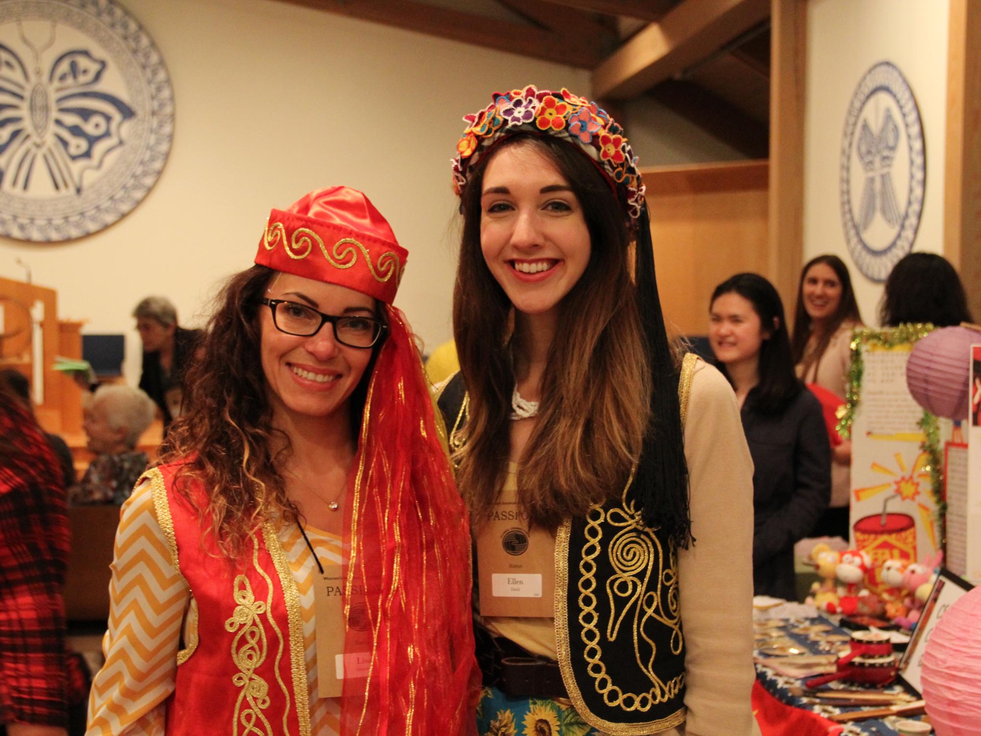 Two women at a celebratory international event, smiling for the camera
