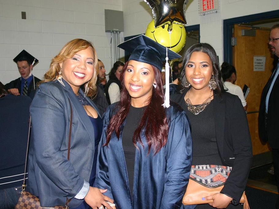 A new graduate celebrates with her family. 