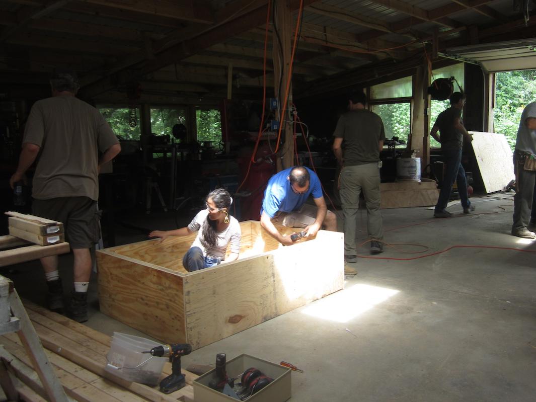 Workshop participants building a frame for the Compressed Earth Blocks (CEBs)