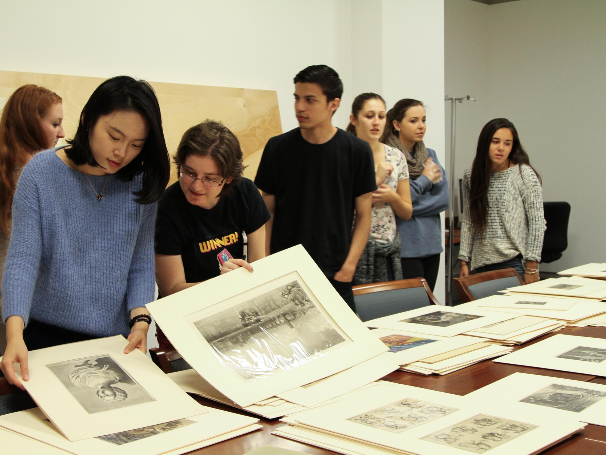 students looking at prints