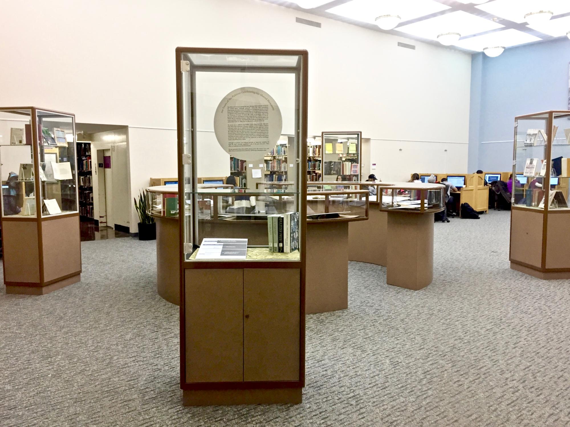 photo of tall and round, mid-size glass exhibit cases
