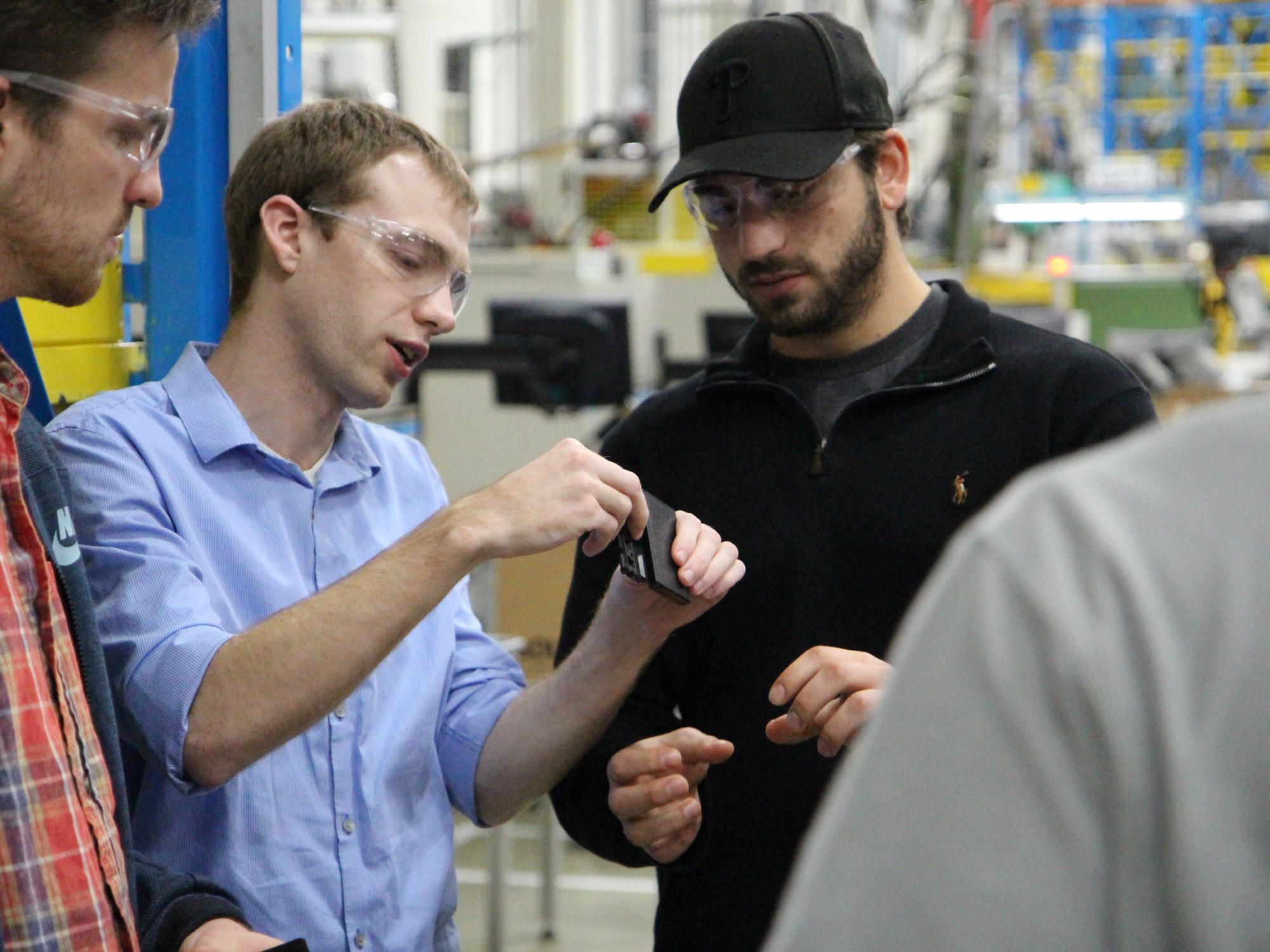 Mitch Engleka, MDE alumnus, showing undergraduate students a hinge for their capstone project