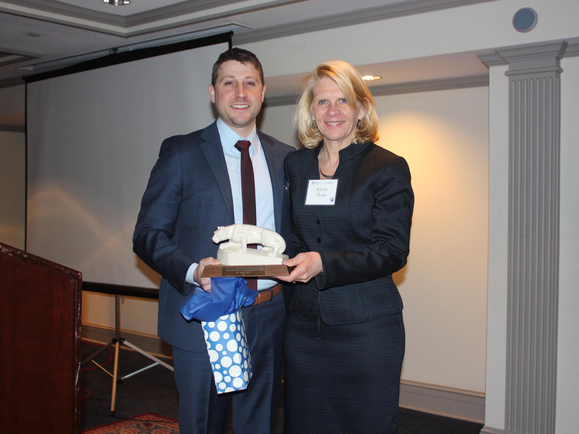 Alan Thrift receives the Early Career Award from Karen Thole, department head, mechanical and nuclear engineering