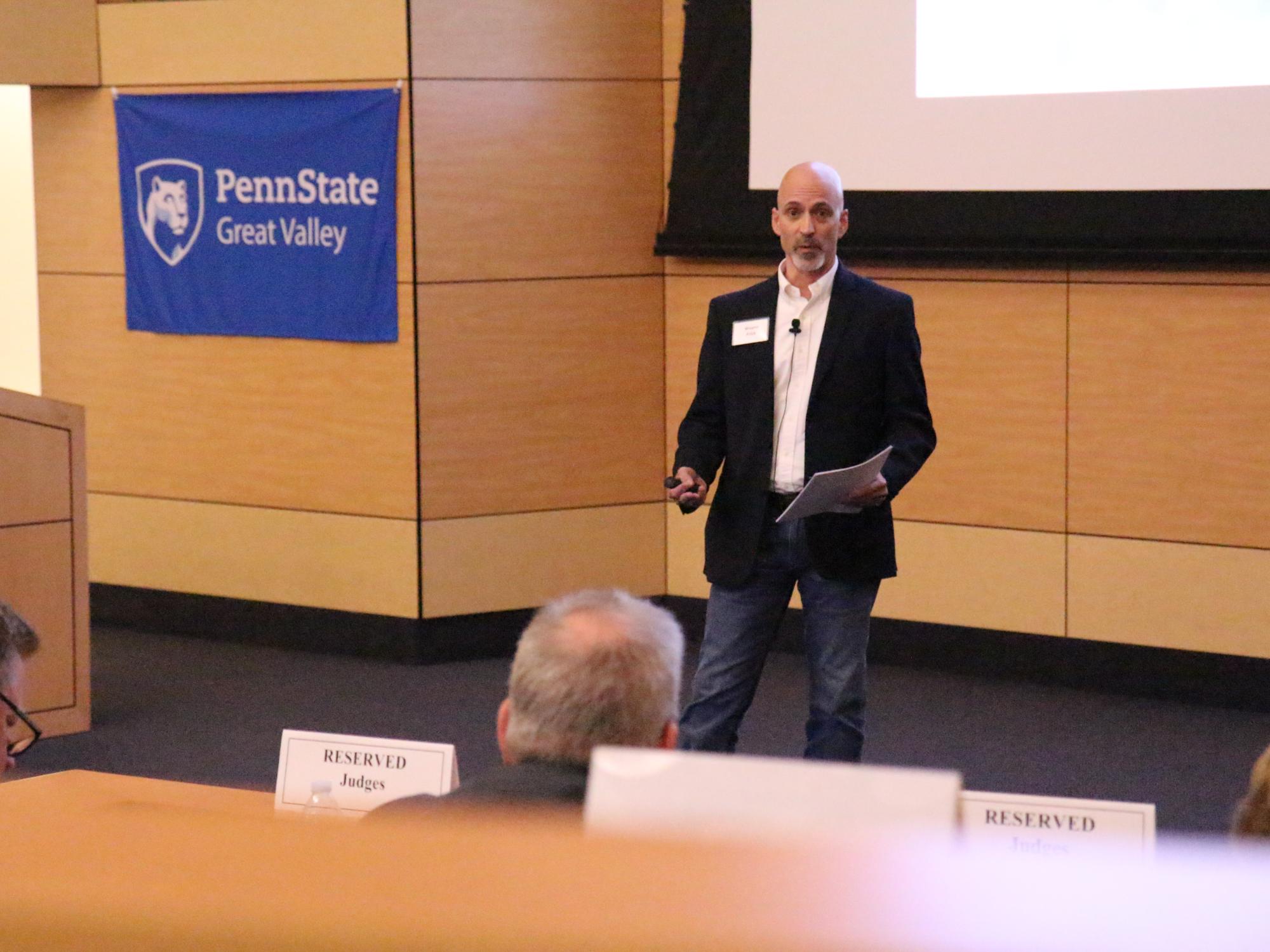 Wayne Frick, founder of Chirpsounds, presents his product at Penn State Great Valley's Lion Cage competition