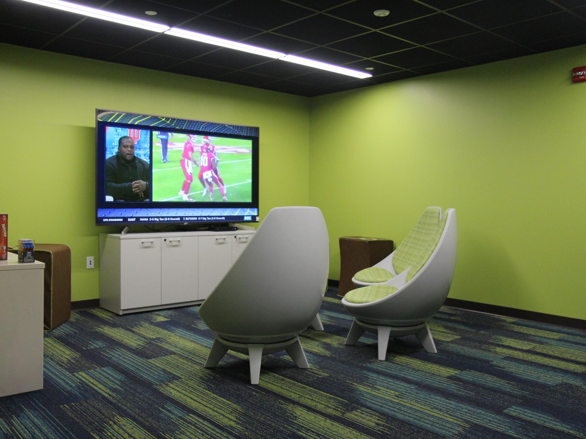 Gaming room with large tv and swivel chairs