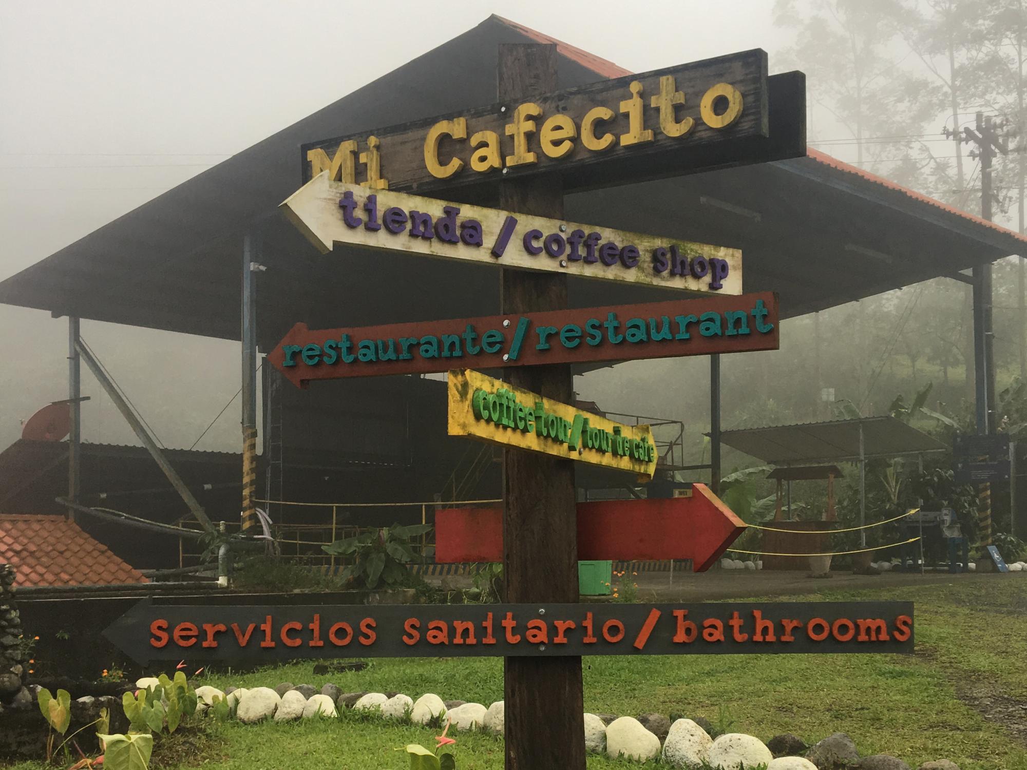 A pole directs visitors to a number of places on this Costa Rican coffee plantation.