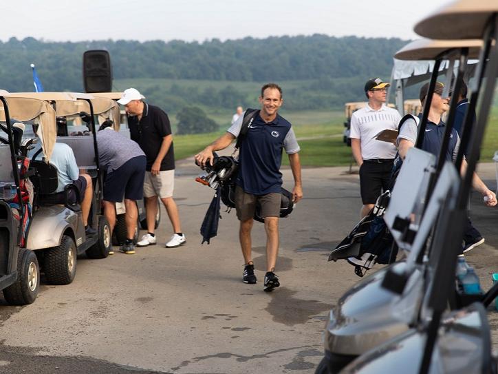Josh Milan walking with golf bag