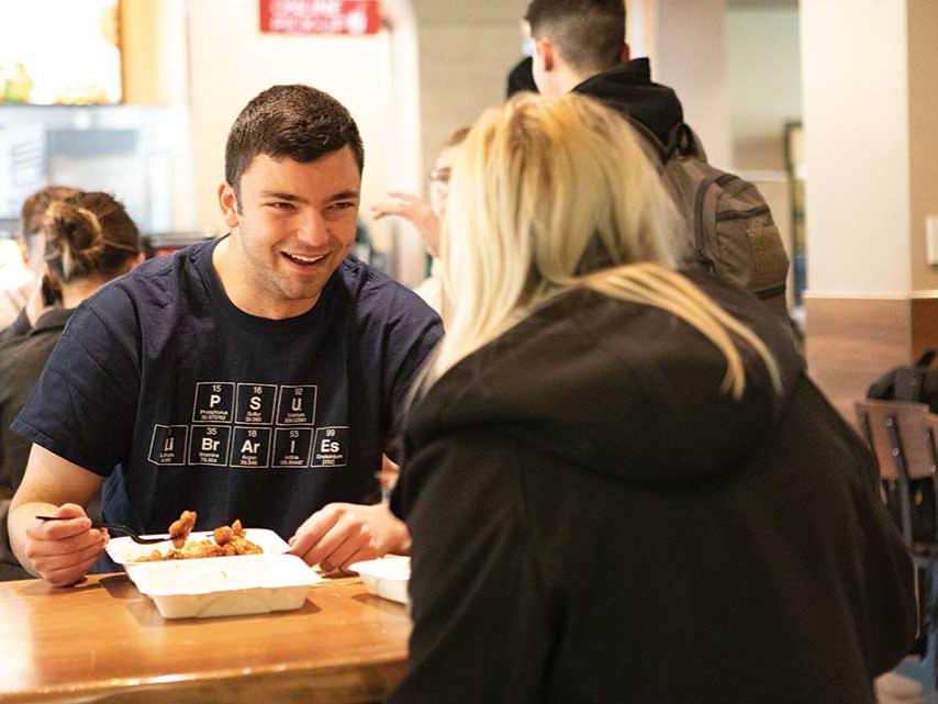 Zach Sowa eats lunch with a female friend.