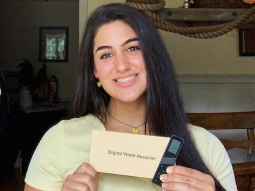 Hanna holding a digital voice recorder