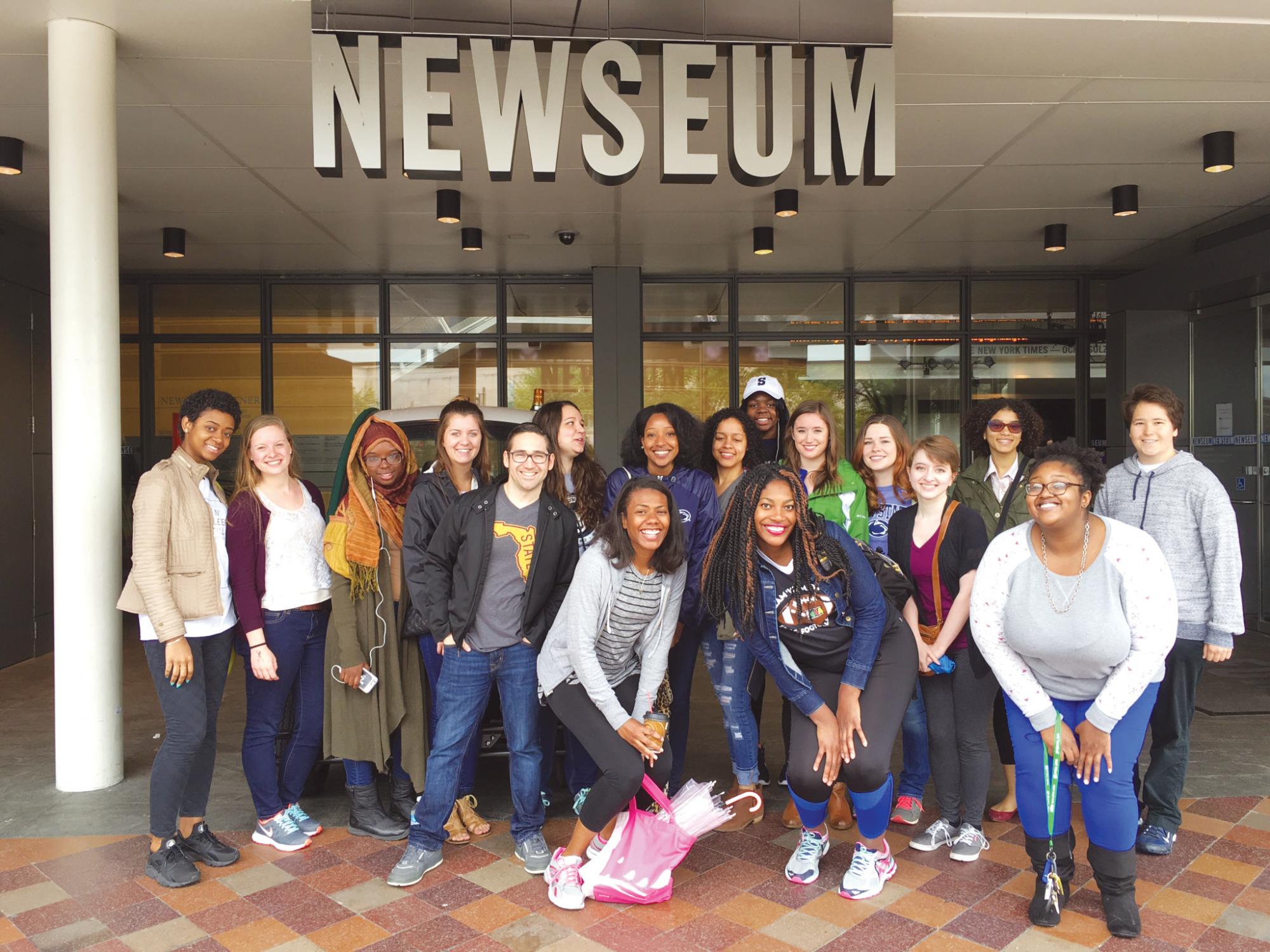 Students posing under the Newseum sign.