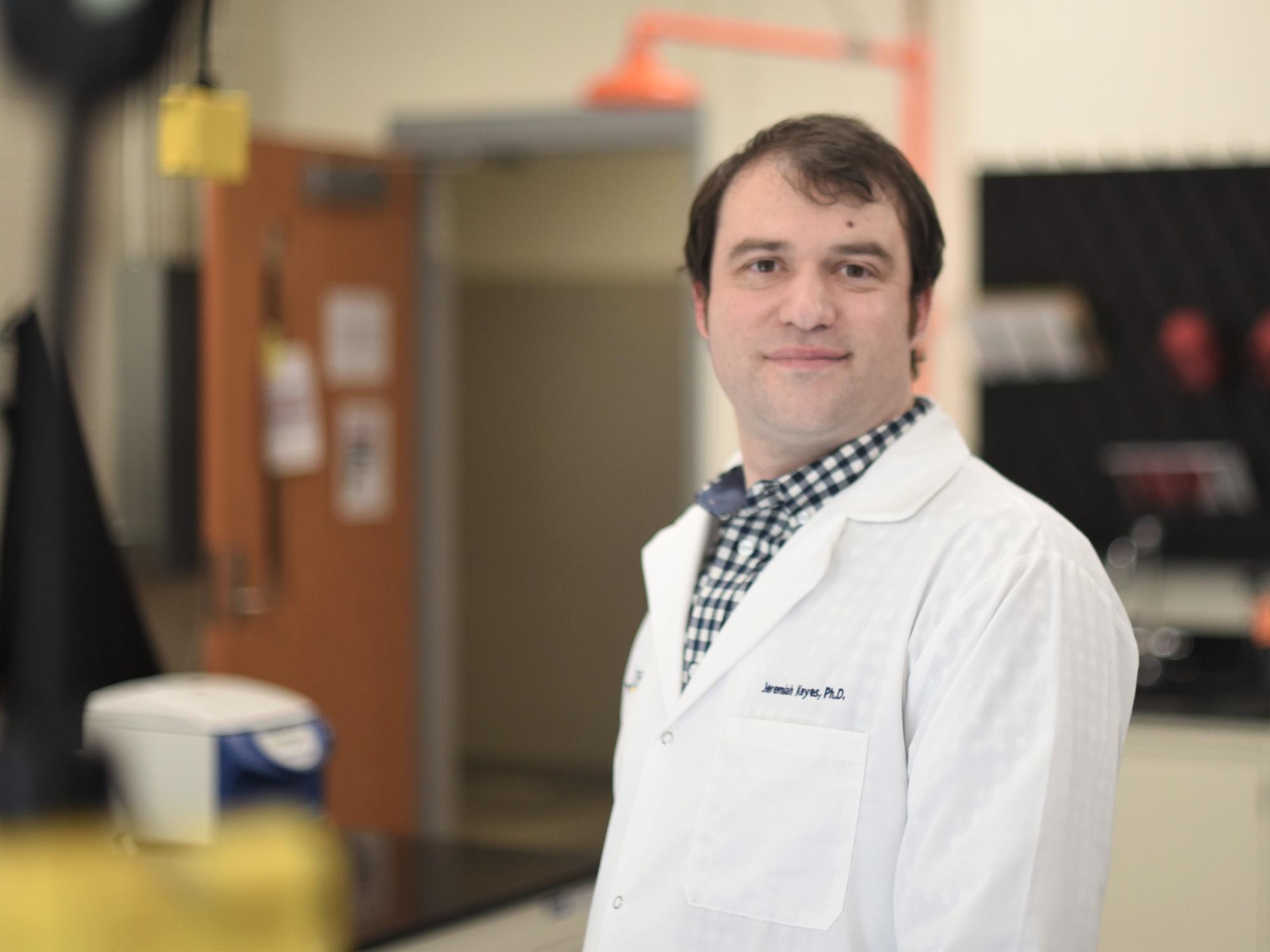 A portrait of Jeremiah Keyes, assistant professor of biochemistry and molecular biology, in a lab at Penn State Behrend.