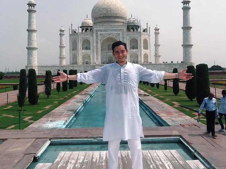 Josh Maldonado-Santiago with arms stretched outside the Taj Mahal