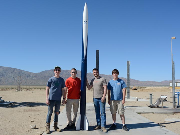 Kale Odhner and his fellow Penn State Berks students pose with their rocket